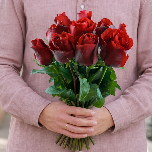 Person holding the 10 ROSES bouquet outdoors, torso only without face