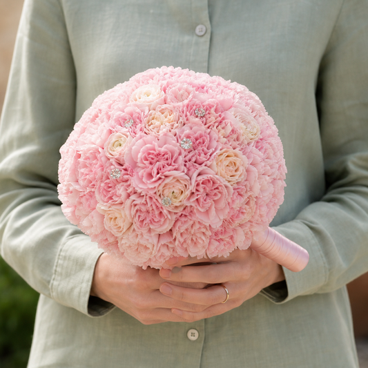 Person holding the 100 ROSES bouquet outdoors, torso only without face