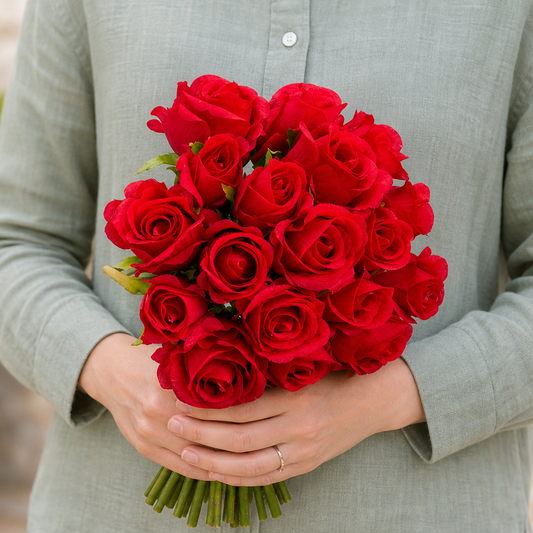Person holding the 12 ROSES bouquet outdoors, torso only without face