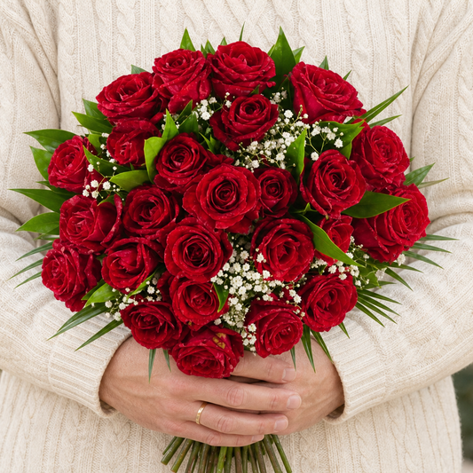 Person holding the 24 ROSES roses outdoors, torso only without face