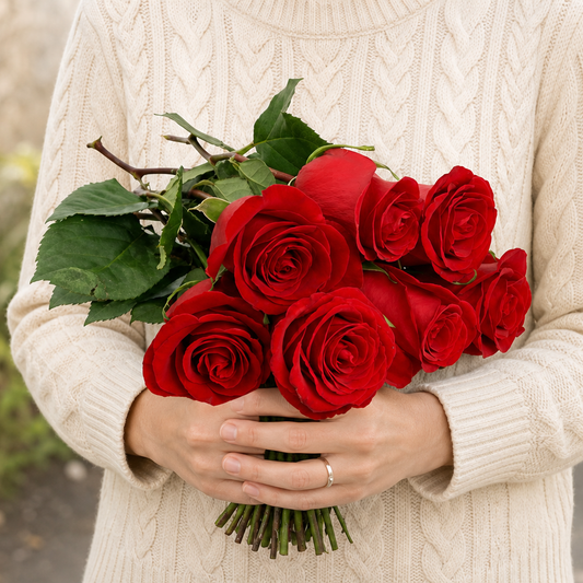 Person holding the 7 ROSES bouquet outdoors, torso only without face