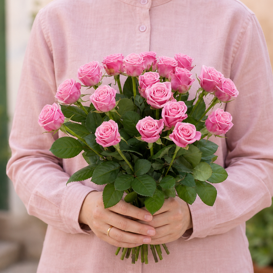 Person holding the AMORE bouquet outdoors, torso only without face