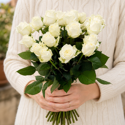 Person holding the ANGEL bouquet outdoors, torso only without face