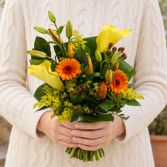 Person holding the AVALANCHE bouquet outdoors, torso only without face