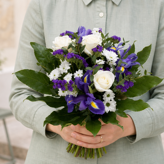 Person holding the BOUQUET bouquet outdoors, torso only without face