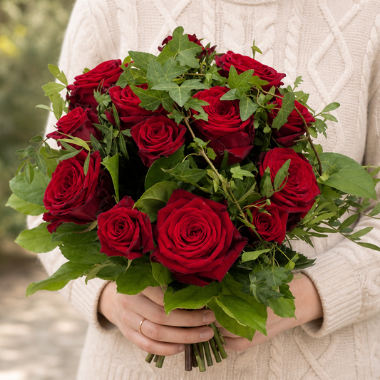 Person holding the CLASSIC bouquet outdoors, torso only without face