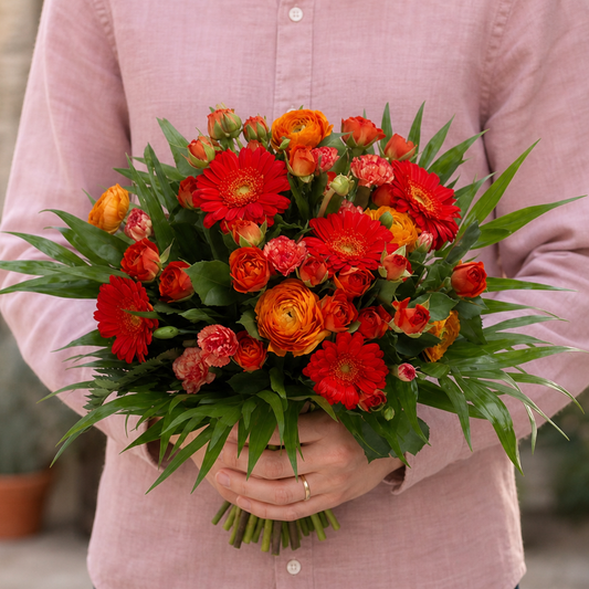 Person holding the DISTINCTION bouquet outdoors, torso only without face