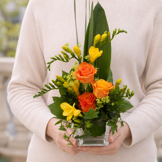 Person holding the FESTIVE bouquet outdoors, torso only without face