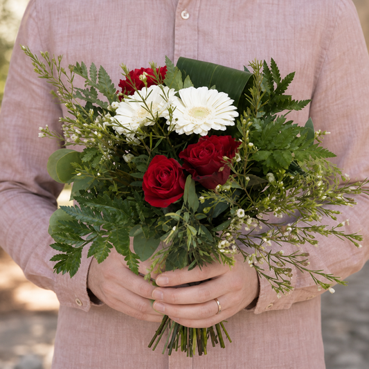 Person holding the FUSION bouquet outdoors, torso only without face