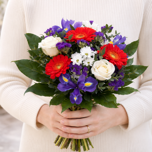 Person holding the GOLDEN bouquet outdoors, torso only without face