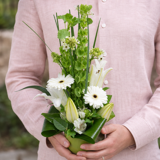 Person holding the GRACE bouquet outdoors, torso only without face