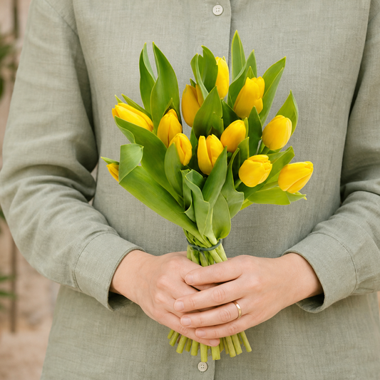 Person holding the IMPRESSION bouquet outdoors, torso only without face