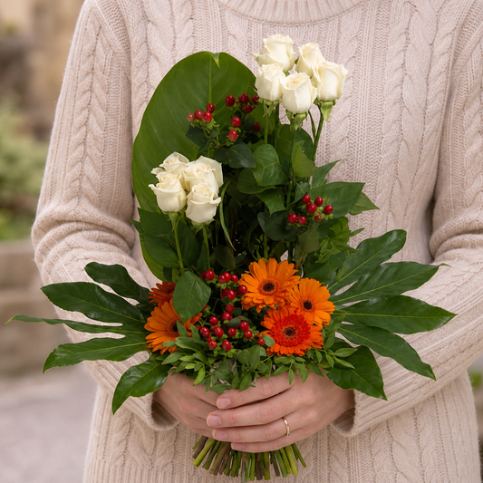 Person holding the MOMENTS bouquet outdoors, torso only without face