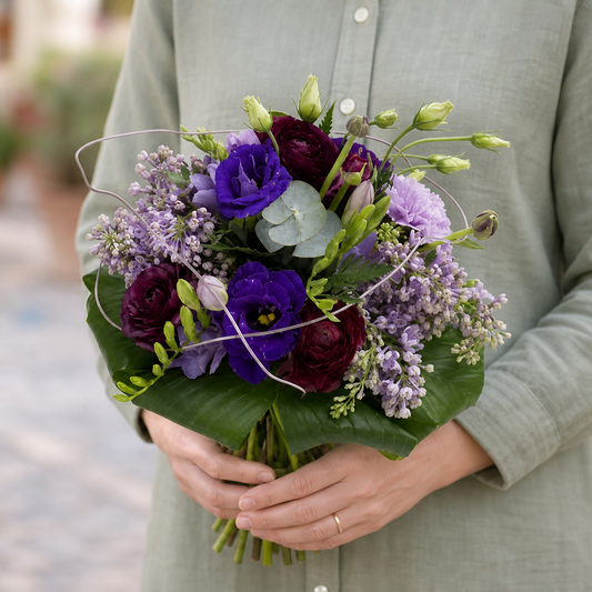 Person holding the PURETE bouquet outdoors, torso only without face