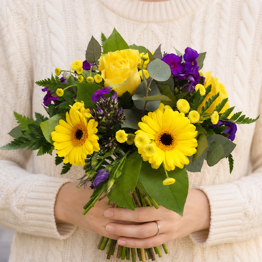Person holding the REASON bouquet outdoors, torso only without face
