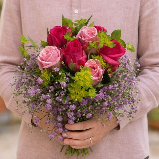 Person holding the REGAL 1 bouquet outdoors, torso only without face