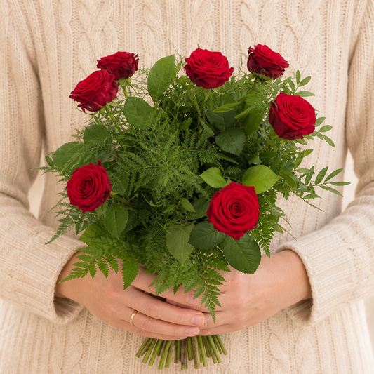 Person holding the SUGAR bouquet outdoors, torso only without face
