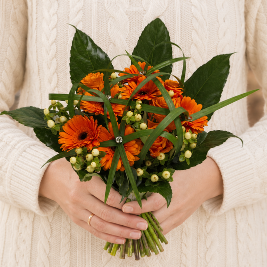 Person holding the SWEET bouquet outdoors, torso only without face