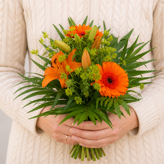 Person holding the VOGUE bouquet outdoors, torso only without face